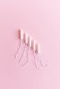 Hygienic tampons arranged on pink surface