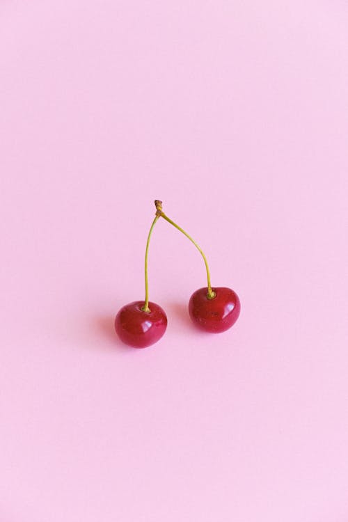 Free Red ripe cherries on pink surface Stock Photo