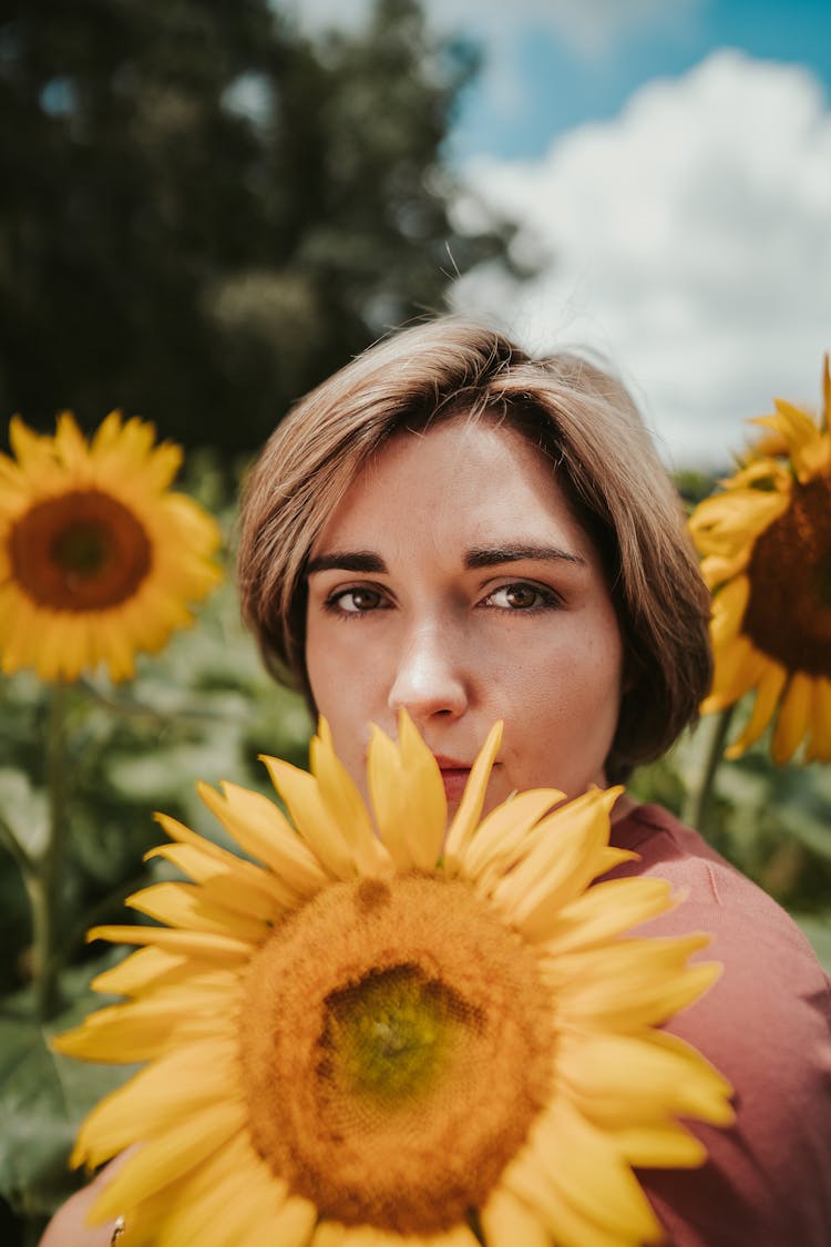 Cute Woman In Sunflower Field