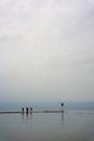People Walking on a Jetty on a Cloudy Day