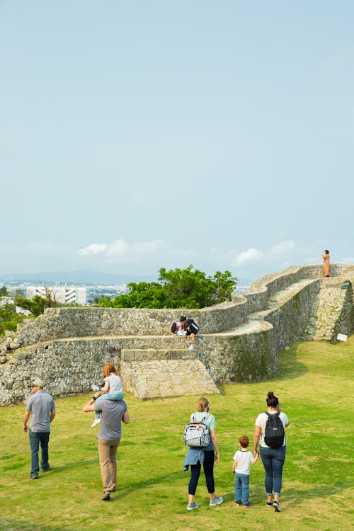 People walking near stone structure