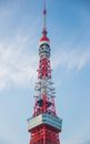 High television tower under cloudy sky in town