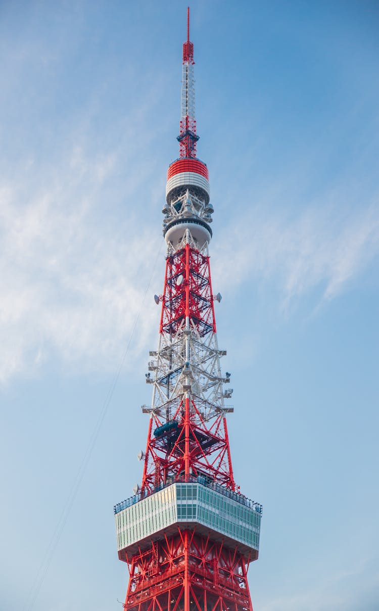 High Television Tower Under Cloudy Sky In Town