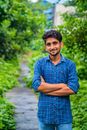 Man in Blue Shirt Smiling near Green Leaves