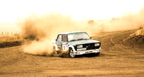 Free Racing Car Driving on Dirt Road Stock Photo