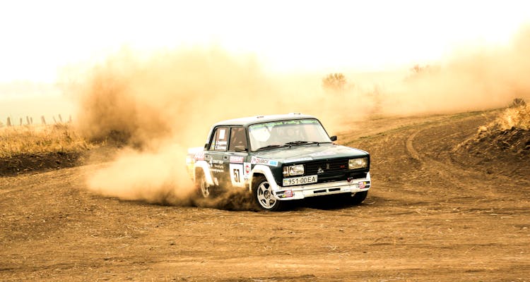 Racing Car Driving On Dirt Road