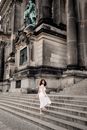 Woman Ascending Stairs of Historical Buil