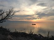 Silhouette of People on Boat on Sea during Sunset