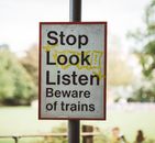 Signboard with Stop Look Listen inscriptions in town