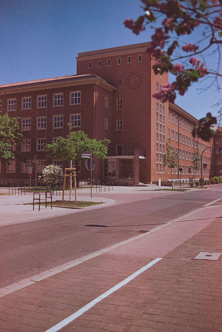 Brown Concrete Building Beside The Road