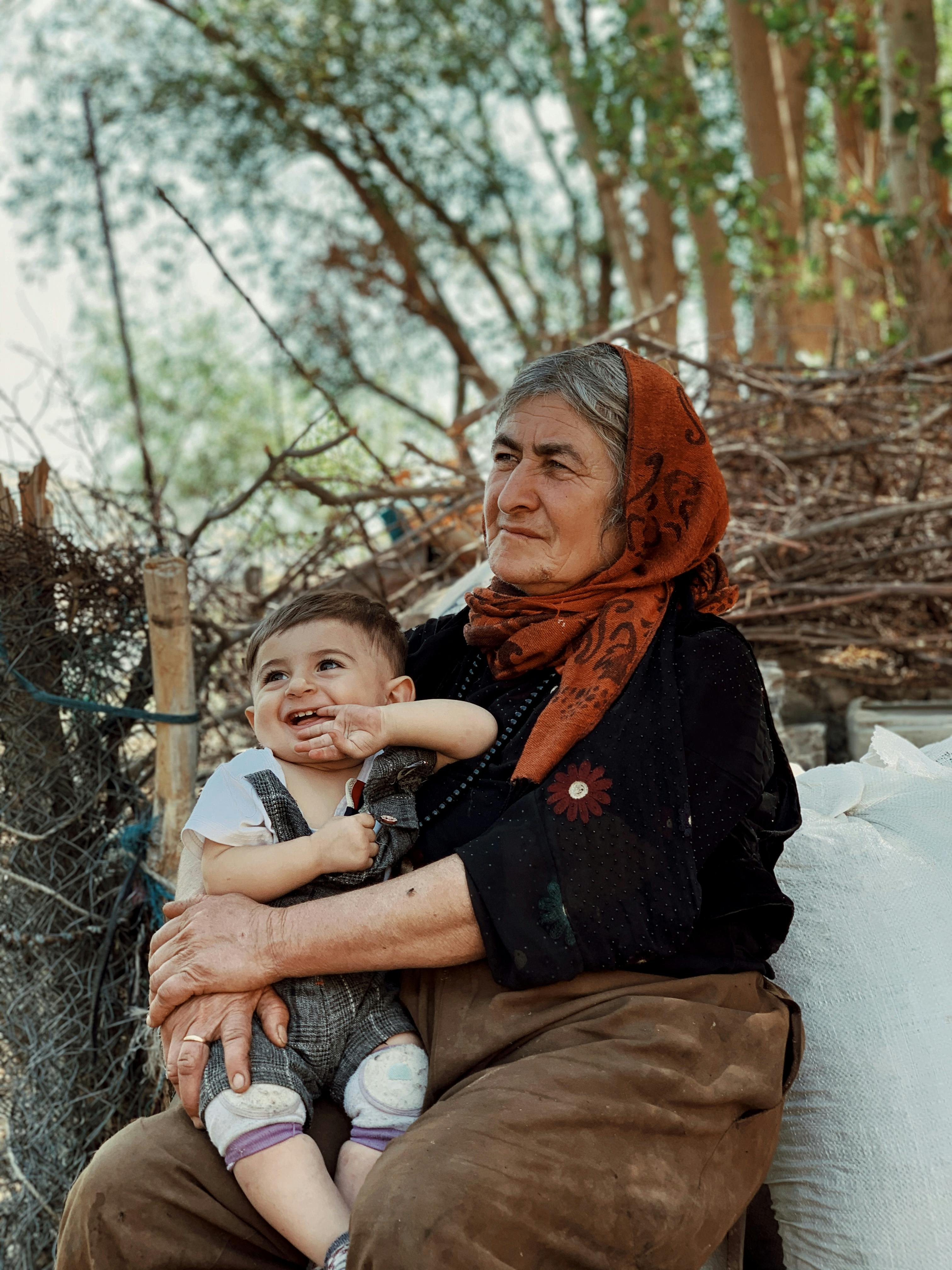 local grandmother with grandson on knees