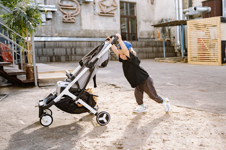 Small Boy Pushing Stroller