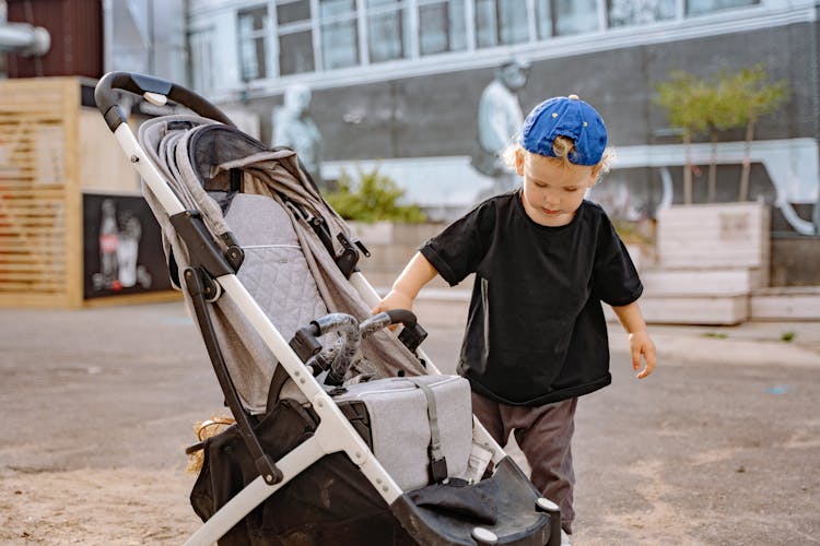 Boy Child Walking Outside Near Stroller