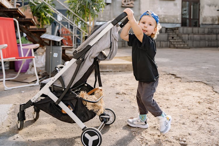 Boy Pushing Stroller