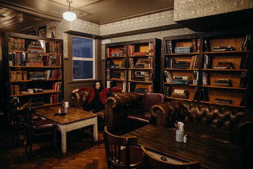 A Woman Sitting on a Leather Sofa