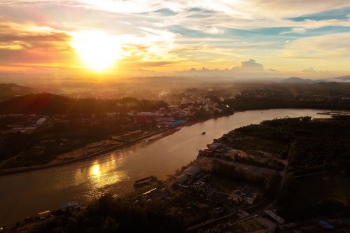 Free Aerial view of picturesque scenery of calm river flowing among city at sunrise Stock Photo