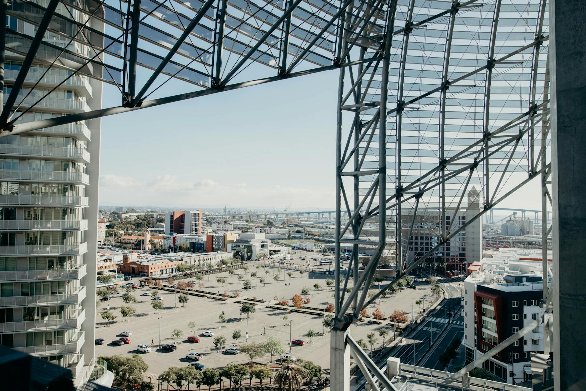 Urban cityscape showcasing modern architecture with steel trusses overlooking a city view.