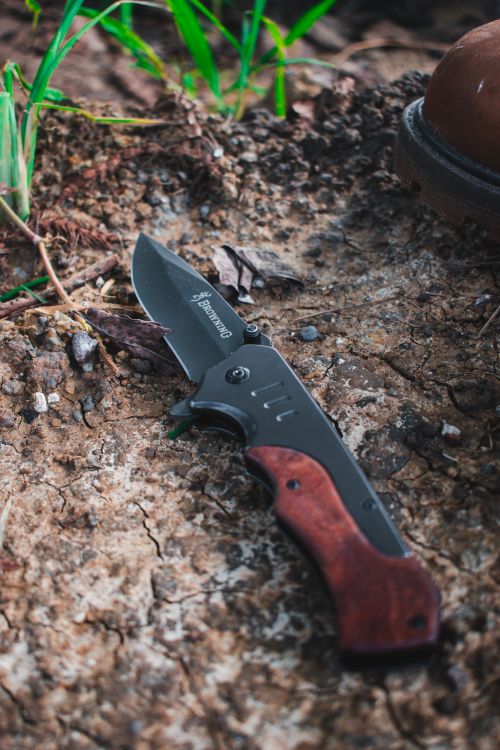 Free Close-up of a folding pocket knife with wooden handle on rustic ground. Stock Photo