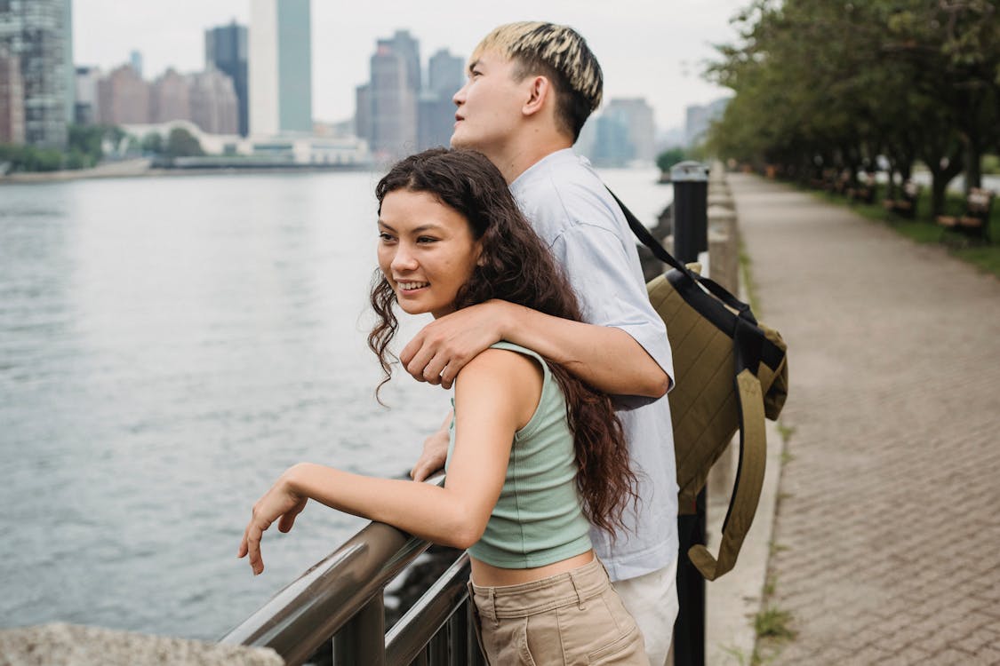 Positive couple spending time together on embankment · Free Stock Photo