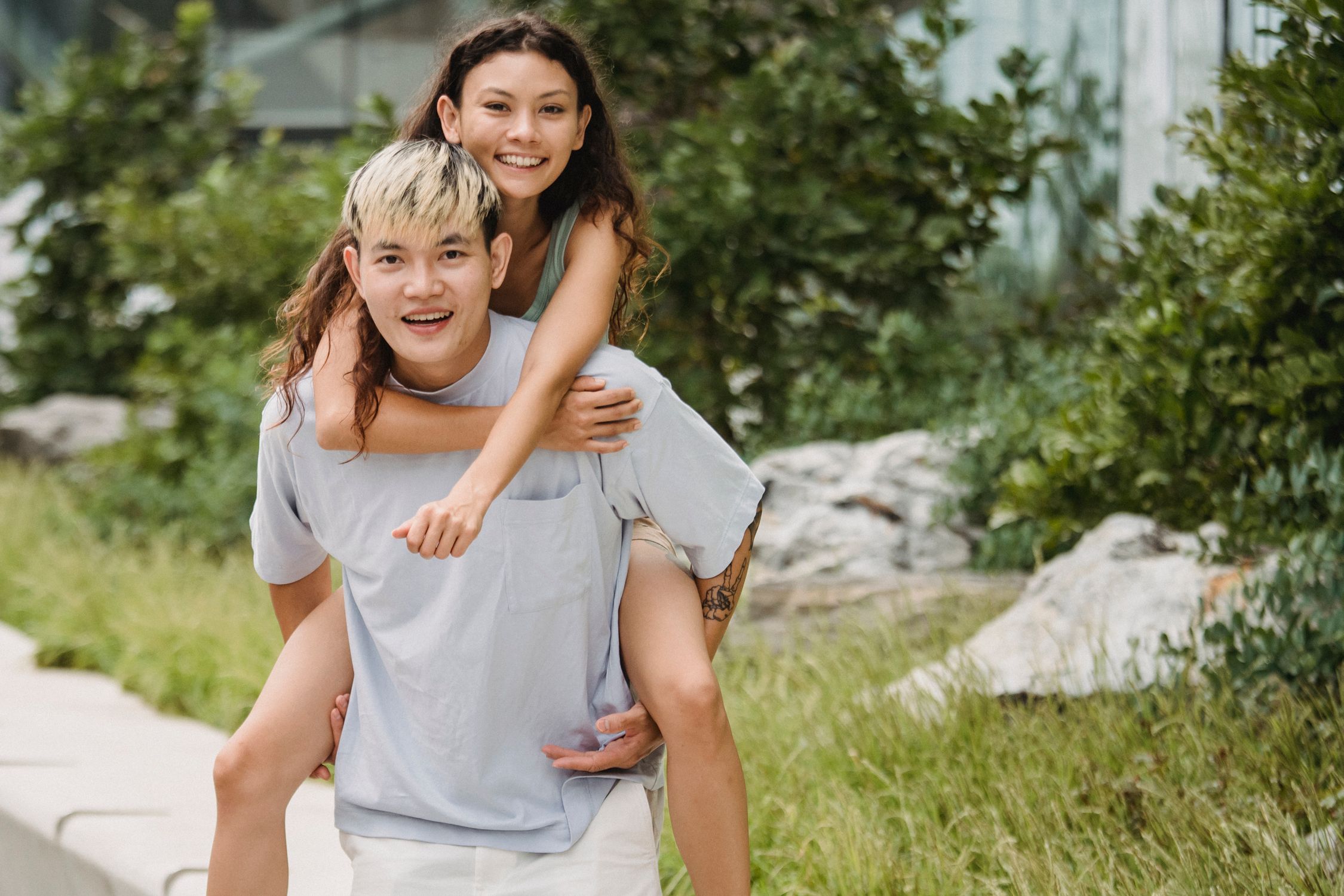 Cheerful Asian Man Carrying Content Ethnic Girlfriend On Back Free cheerful-asian-man-carrying-content-ethnic-girlfriend-on-back-free