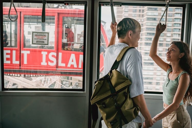 Smiling Multiracial Couple Interacting In Cable Cabin During Trip