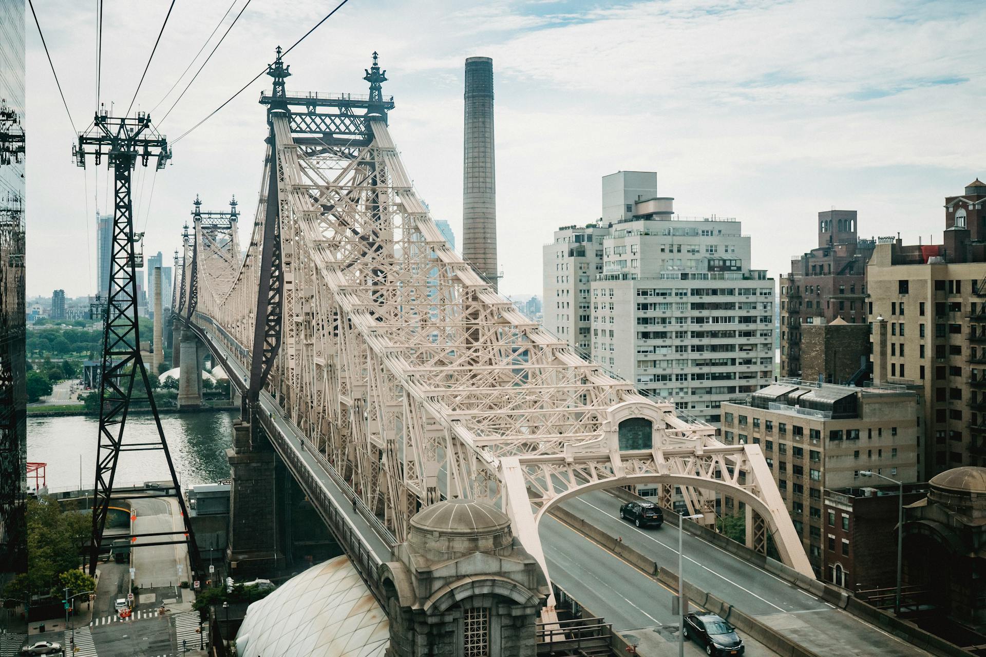 View of the iconic Queensboro Bridge spanning the East River with Manhattan buildings.