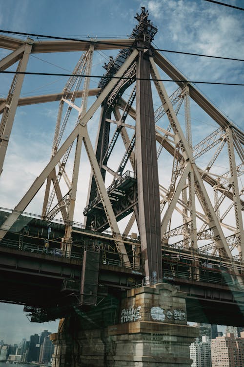 Contemporary cantilever bridge located over river in urban big city under blue sky