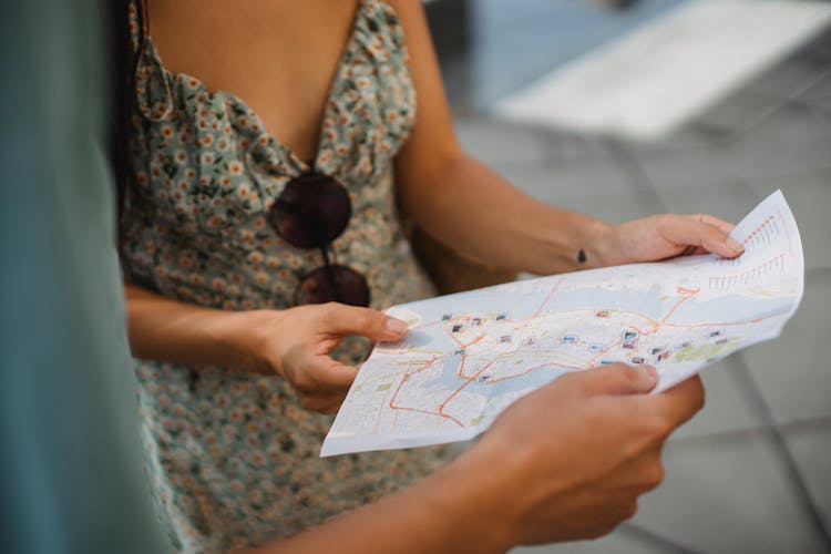 Crop Faceless Couple Checking Direction On City Map