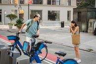 Diverse friends preparing for riding bicycles and taking photo