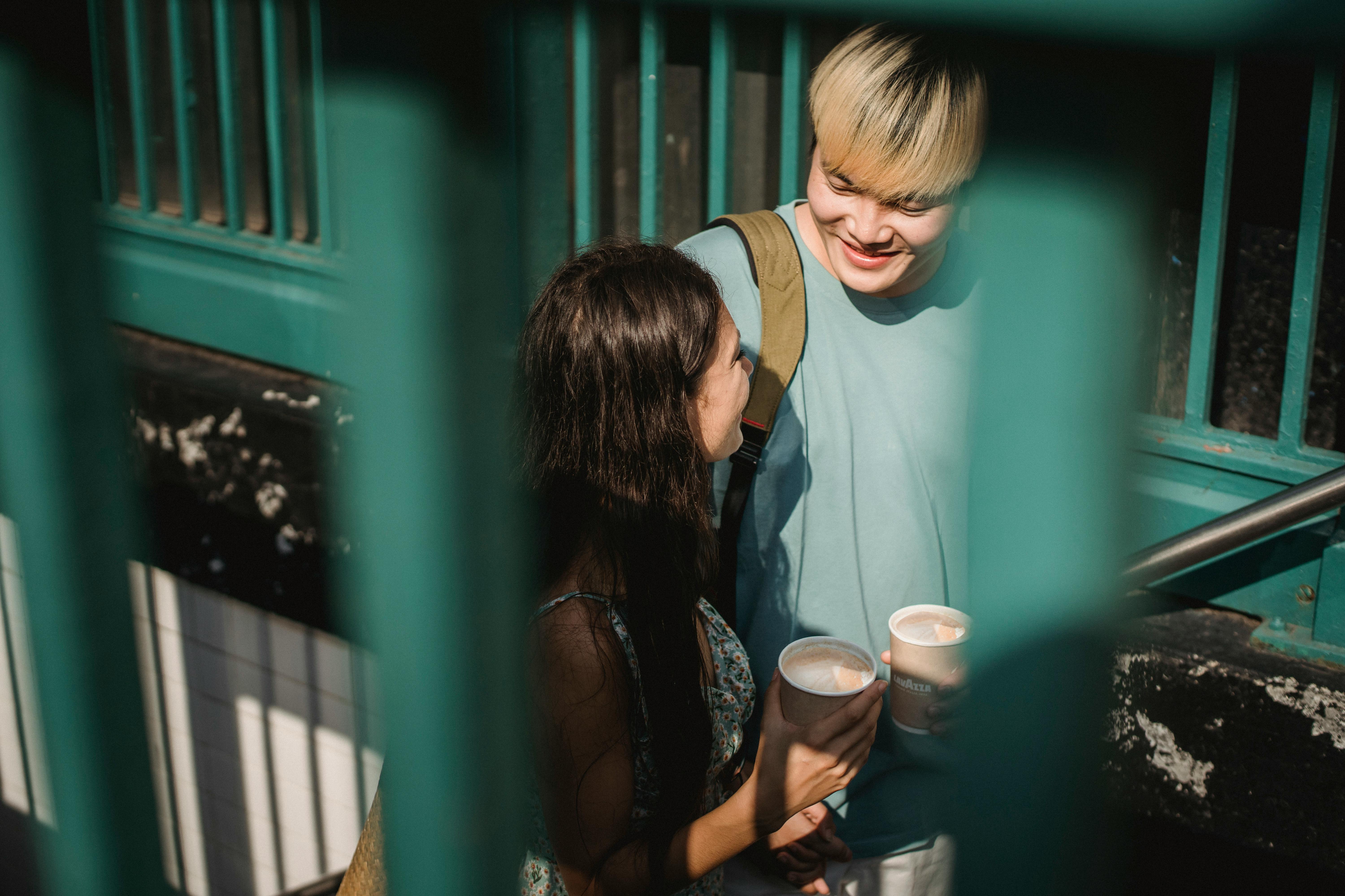 happy smiling diverse couple with coffee