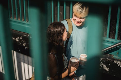 Free Happy smiling diverse couple with coffee Stock Photo