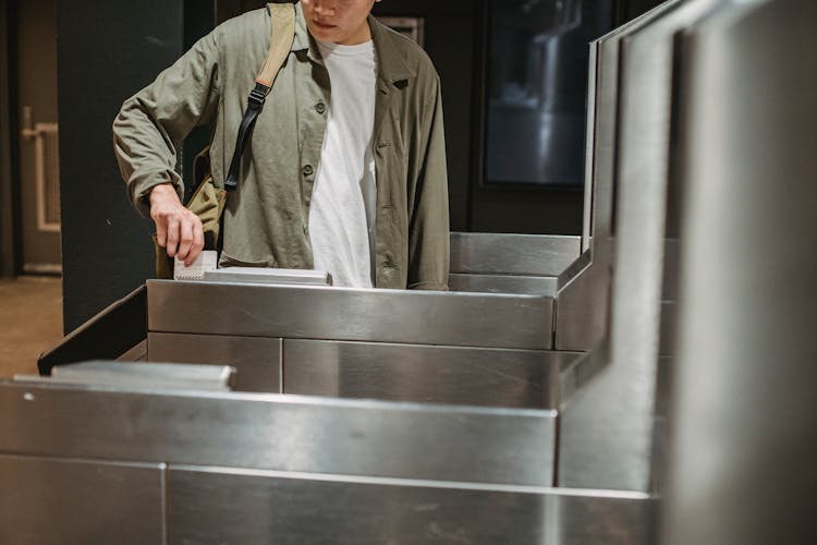 Crop Man Using Card To Enter City Subway Gate