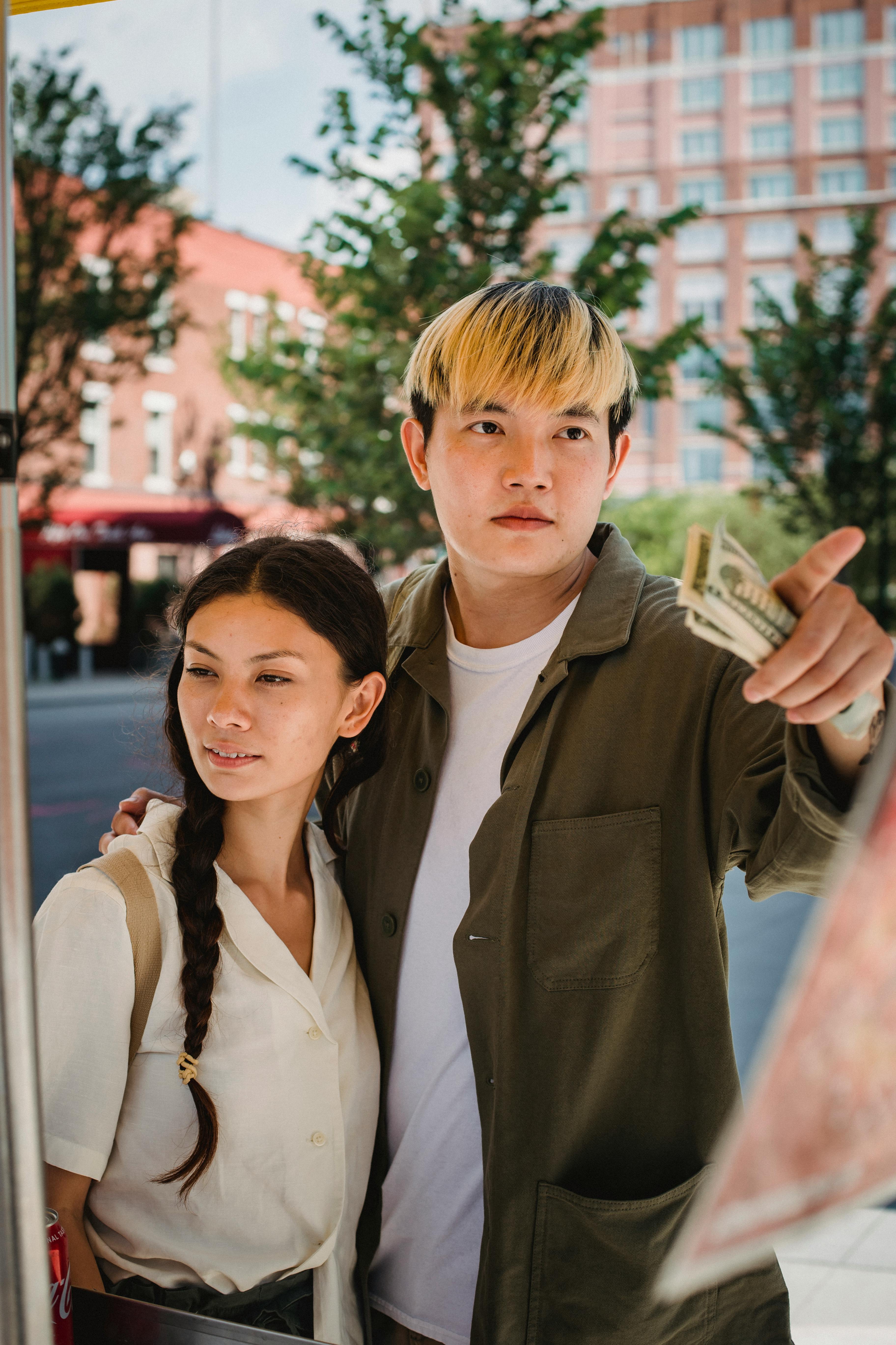 young asian couple ordering food in street cafe