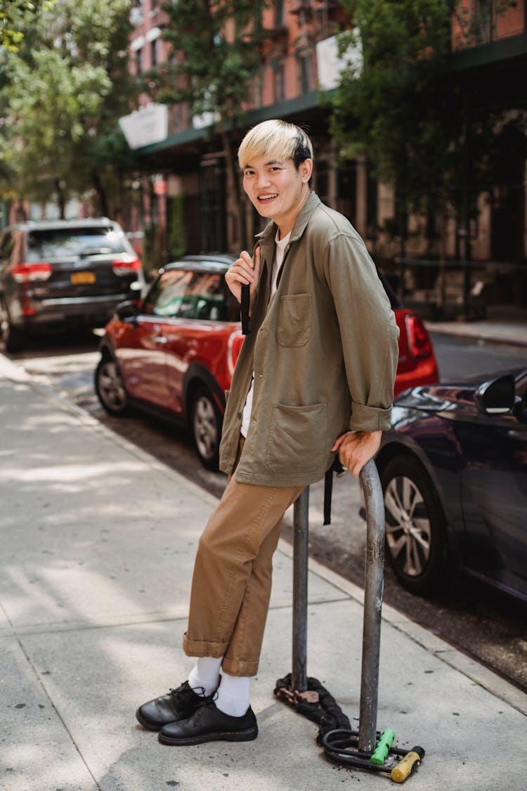 Content Asian Man Standing On Town Street