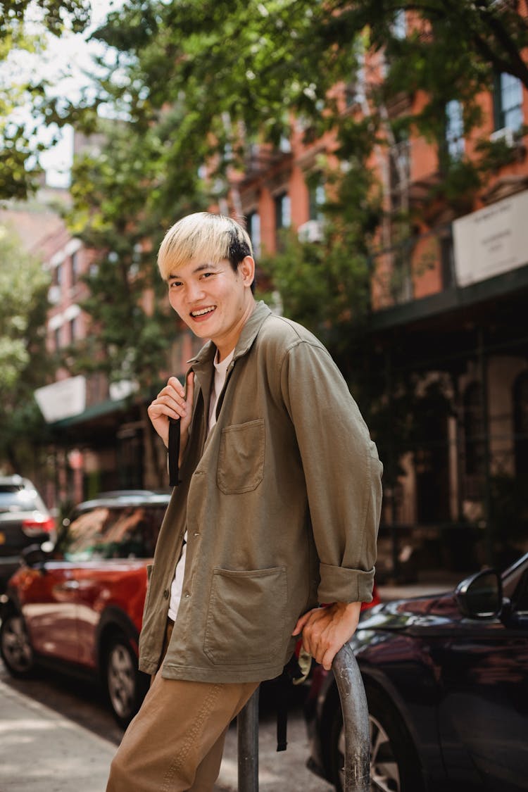 Smiling Asian Man On Pavement In Town