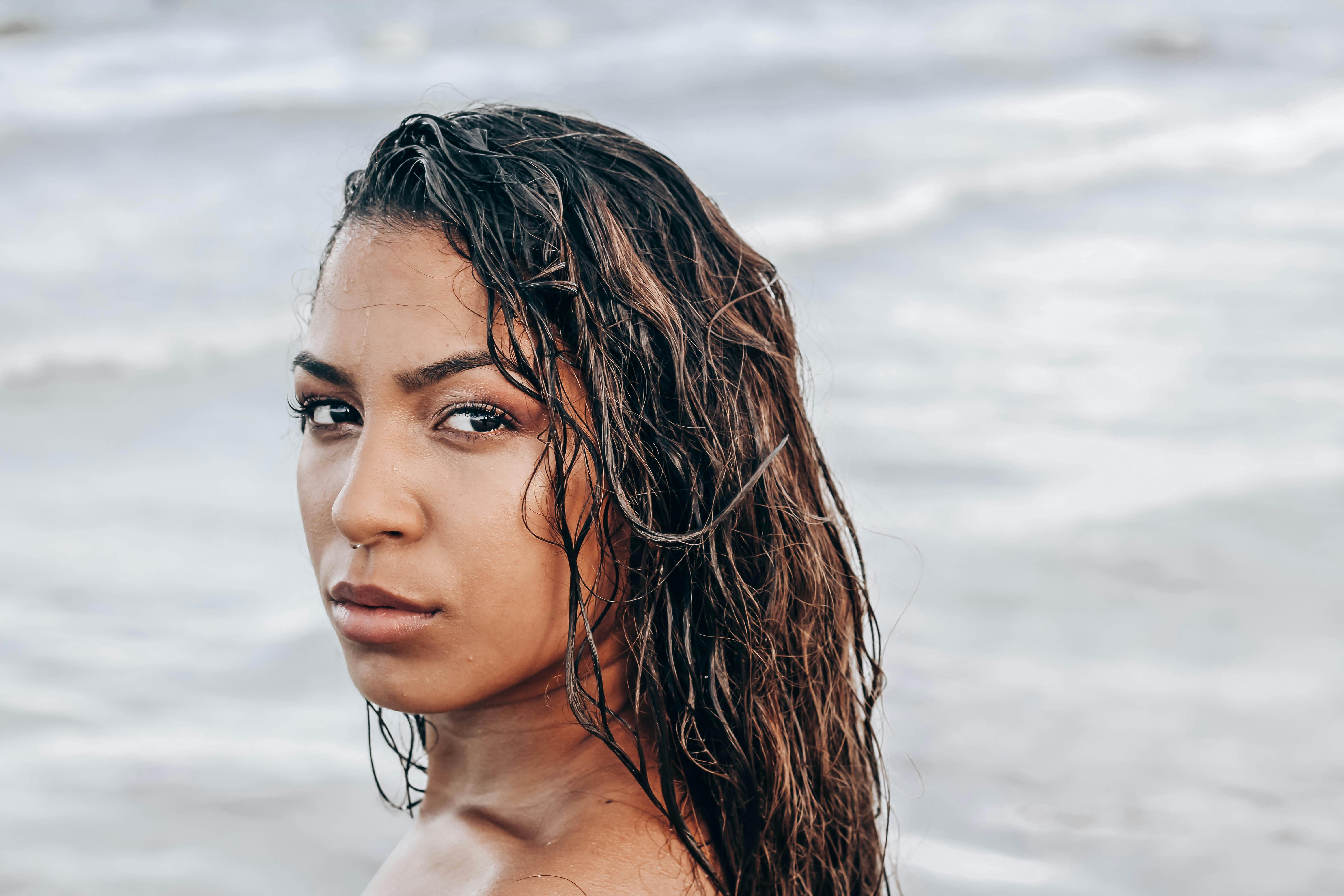 gorgeous ethnic woman standing against waving sea