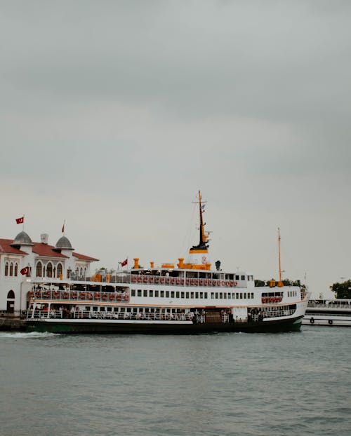 White and Red Ferry Sailing on Sea