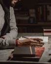 Man Reading Book with Pen in Hand 