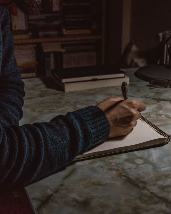 Close-up of a Man Making Notes · Free Stock Photo