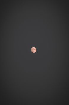 A mesmerizing full moon surrounded by a vast, dark night sky, perfect for mobile wallpaper.