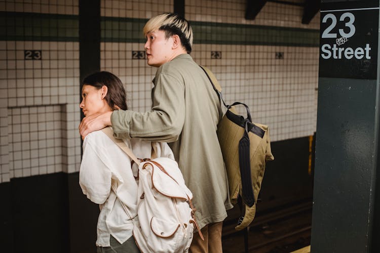 Focused Asian Couple Waiting For Train