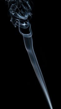 A captivating image of swirling smoke against a dark backdrop, perfect for artistic projects.