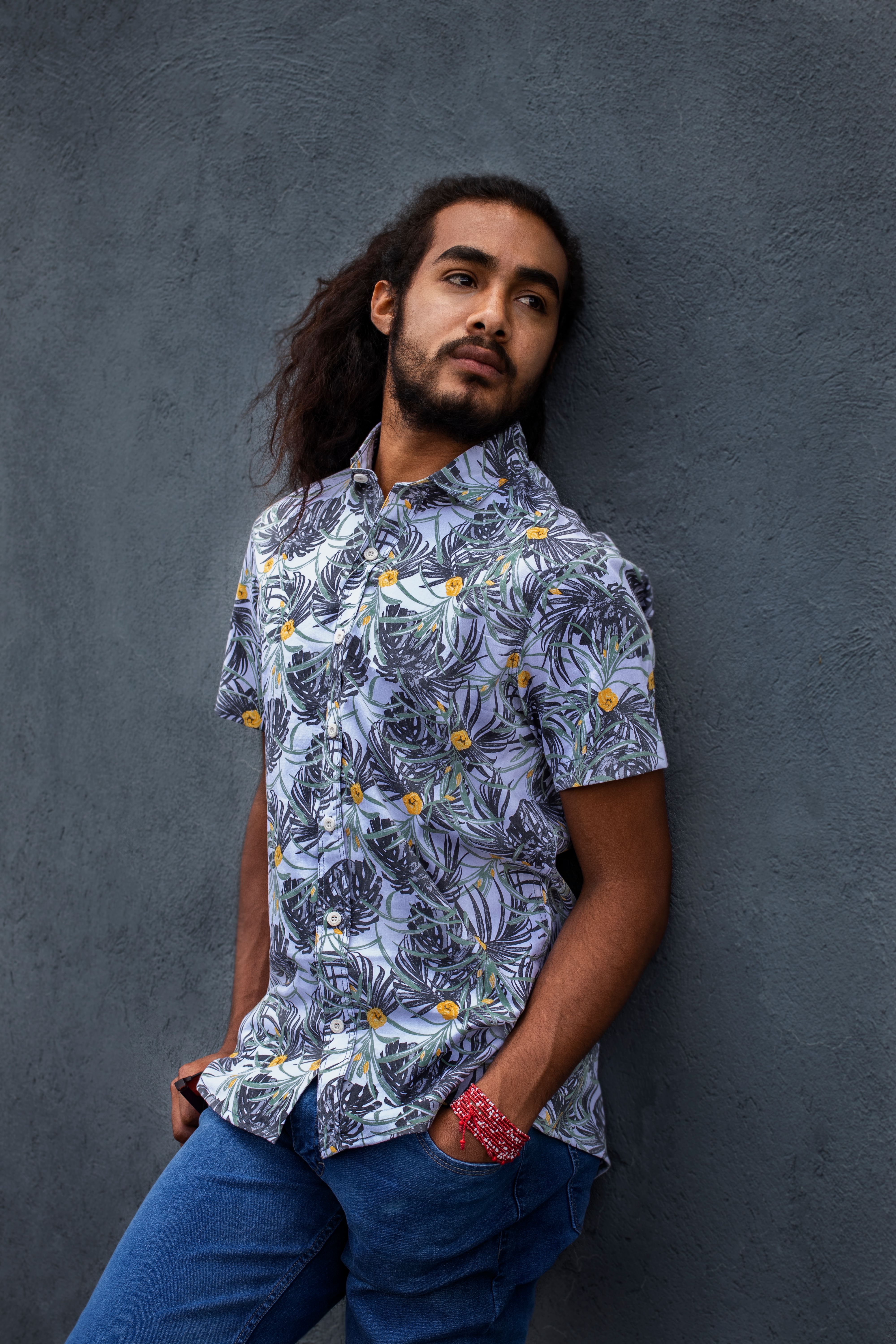 A Man in Floral Shirt Standing Beside Gray Wall · Free Stock Photo