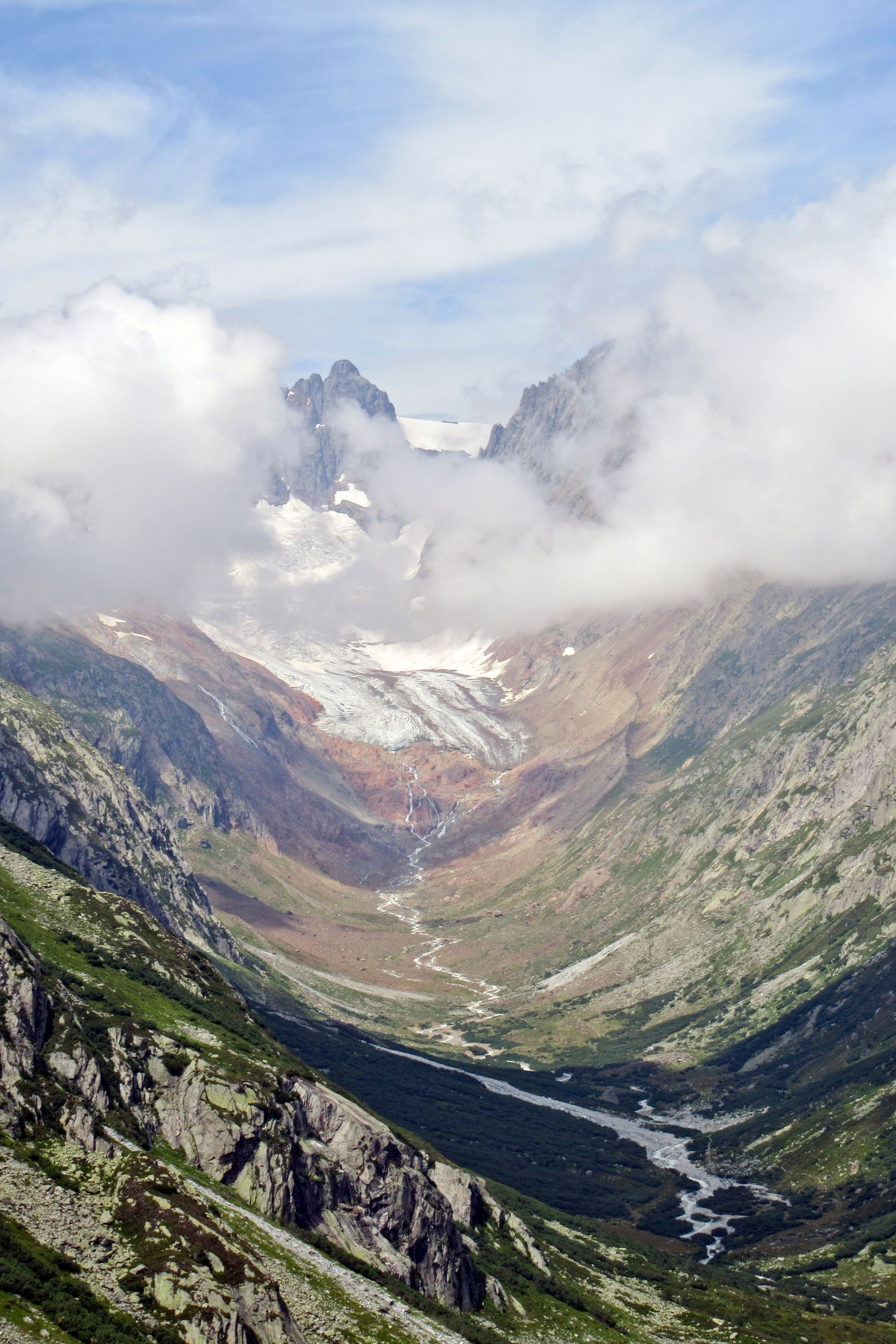 A Mountain with Snow Under Cloudy Sky · Free Stock Photo