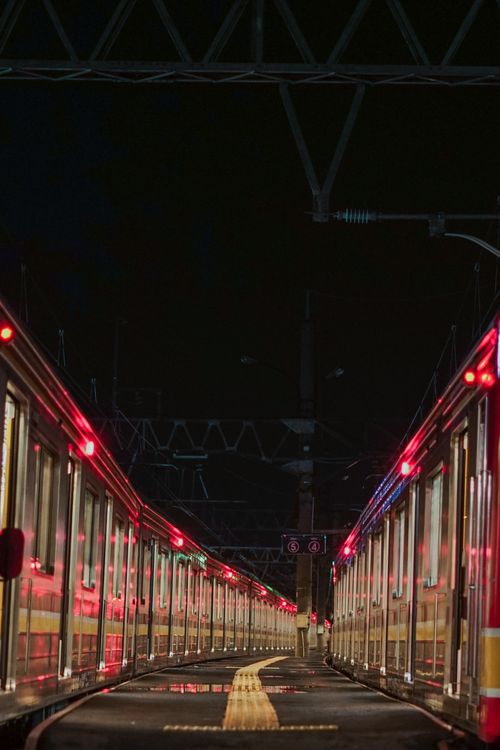 Free Dramatic night scene of trains at a station, capturing symmetry and reflections. Stock Photo