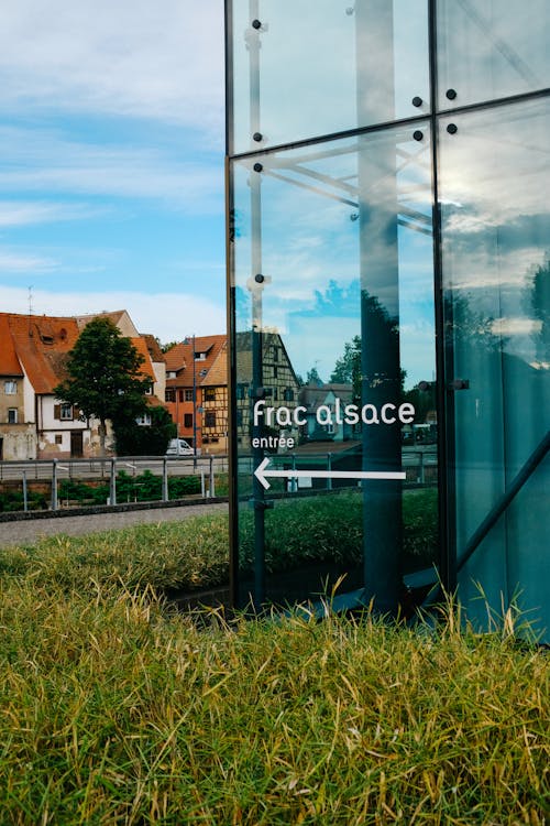 Glass building with direction sign in modern town