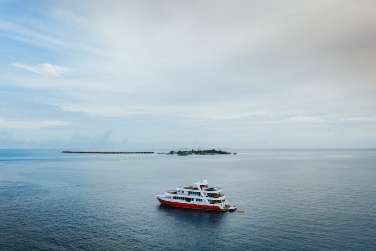 Modern Cruise Ship Sailing On Sea Near Small Island