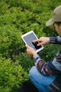 Man using tablet for working in greenhouse