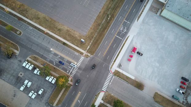 Aerial view of an intersection with surrounding parking lots and roadways.