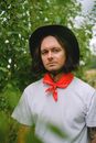 Serious farmer in hand and red bandana in farm